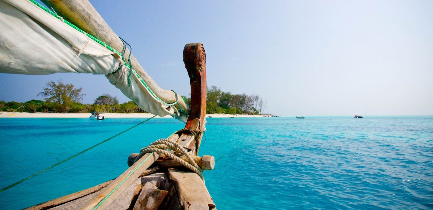 Dhow sailing on ocean and mnemba island