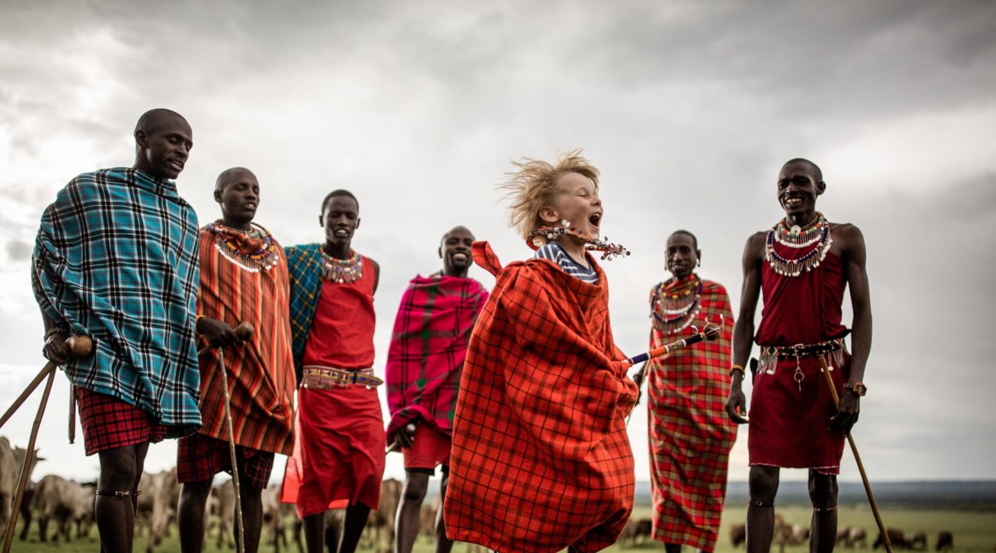 Maasai tribe standing in front of wildebeest