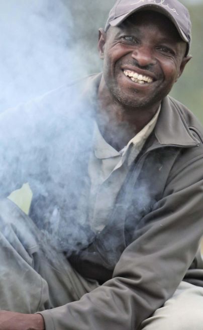 Asilia Ol Pejeta Bush Camp Staff prepping the bush fire for evening sundowners