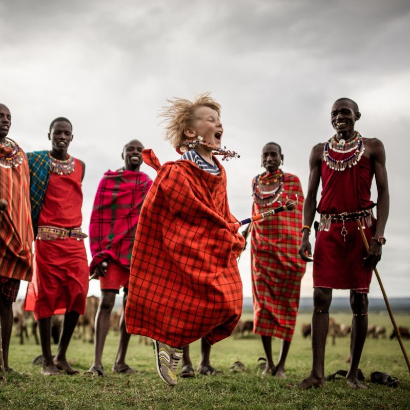 Maasai tribe standing in front of wildebeest